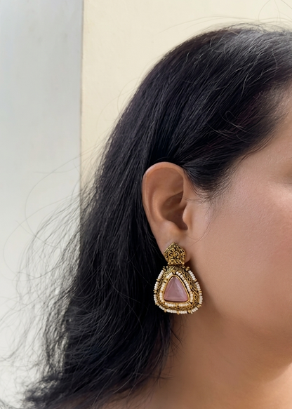 Earring worn by a person with a neutral background